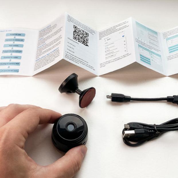 person holds MiniPix Camera instructions