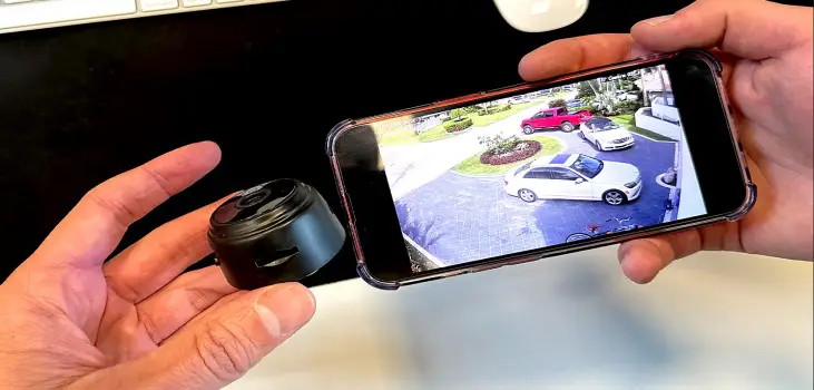 person holding MiniPix Camera next to their phone